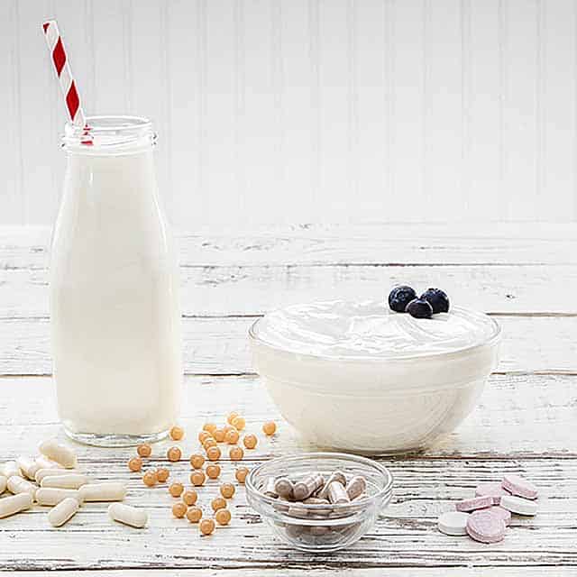 Glass bottle of milk, yogurt and vitamins