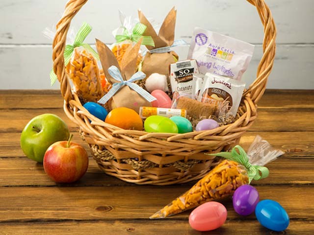Easter basket with apples, plastic eggs and crackers
