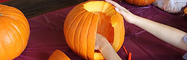 Woman carving pumpkin