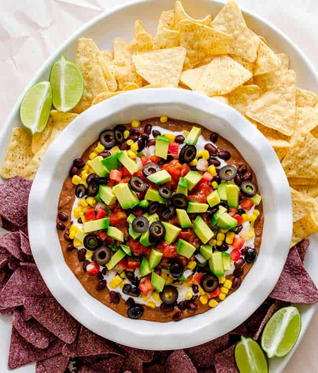 7 Layer Fiesta Dip and chips with fresh cut lime