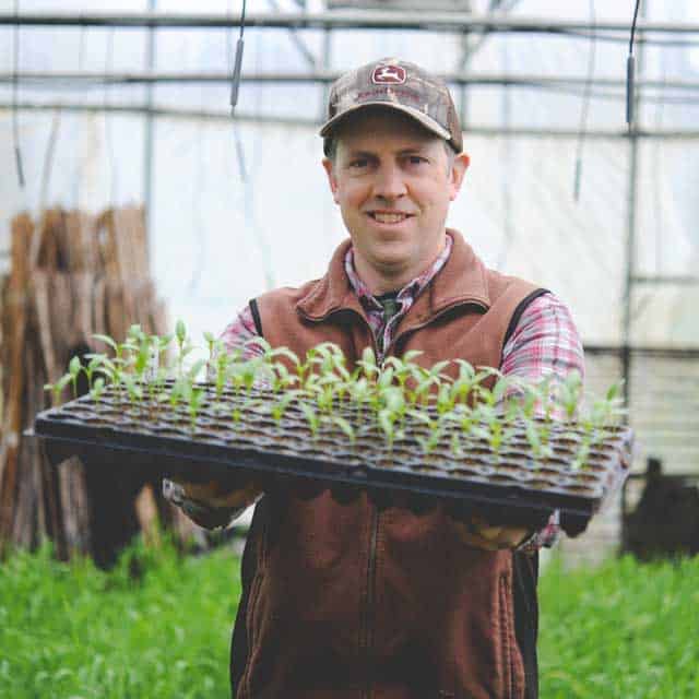 farmer holding new sproutlings