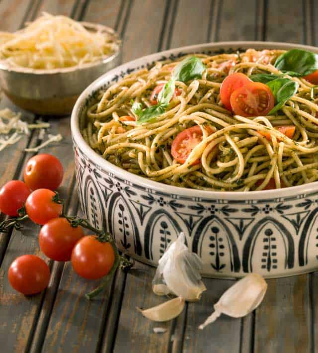 Avocado Pasta Dish with bowl of shredded cheese and grape tomatoes on the side