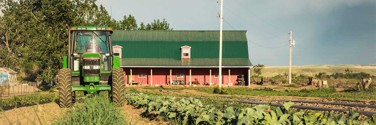 Organic certified food labels: agricultural field with tractor and barn in background 