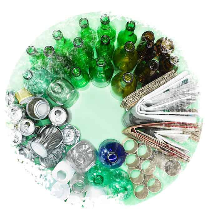 Recycling facts: Various bottles, cans and newspapers arranged in circular design