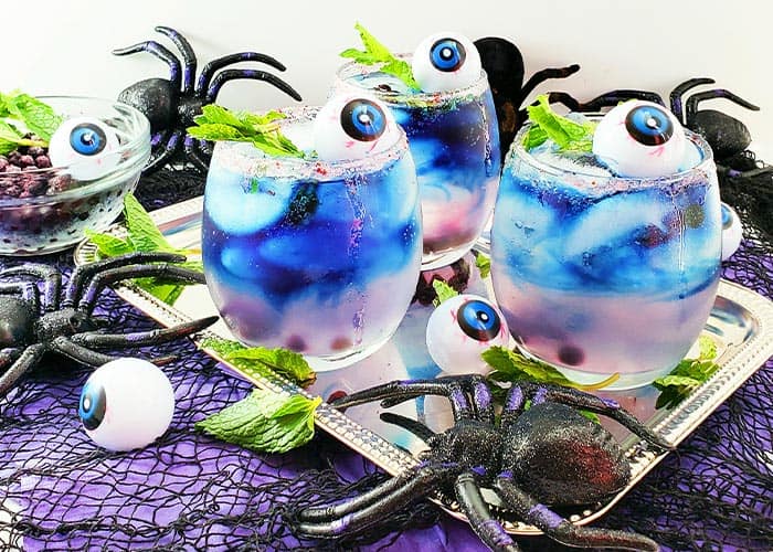 Blue lemonade in glasses with halloween decorations