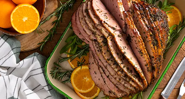herb citrus rubbed ham in a baking pan