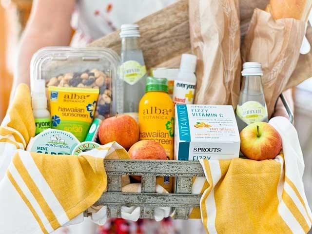 Hands holding a basket of products