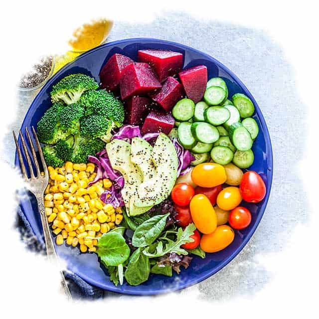 A plate of fresh produce including beets, broccoli, tomatoes and spinach.