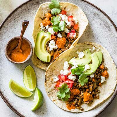 Lentil Tacos on a Plate With Avocado and Lime