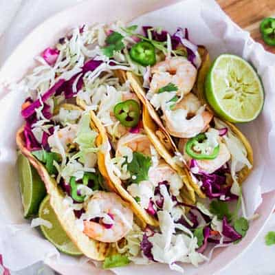 Shrimp Tacos on a Plate with Lime and Cabbage