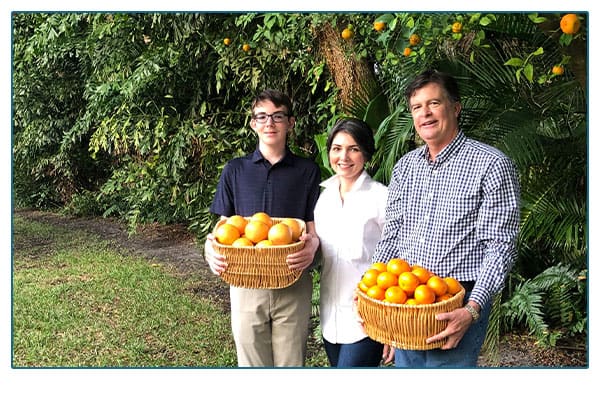 Egan family holding baskets of citrus.