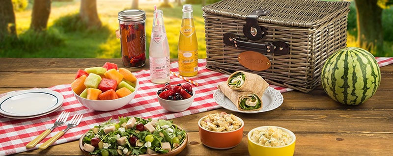 Picnic laid out on a wooden table.