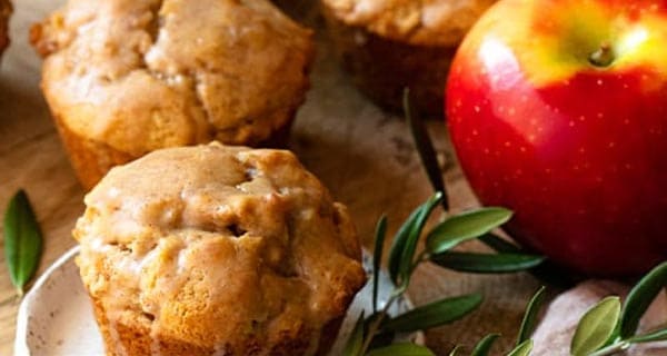 Apple cinnamon muffins next to an apple