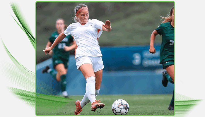 Amber playing soccer on a field