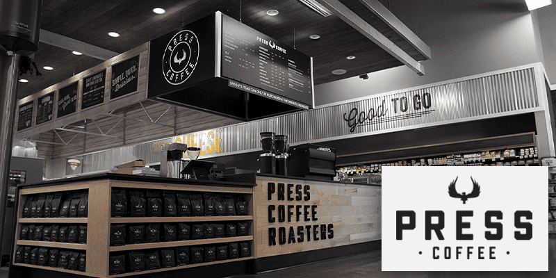 press coffee logo in front of photo of the in-store kiosk