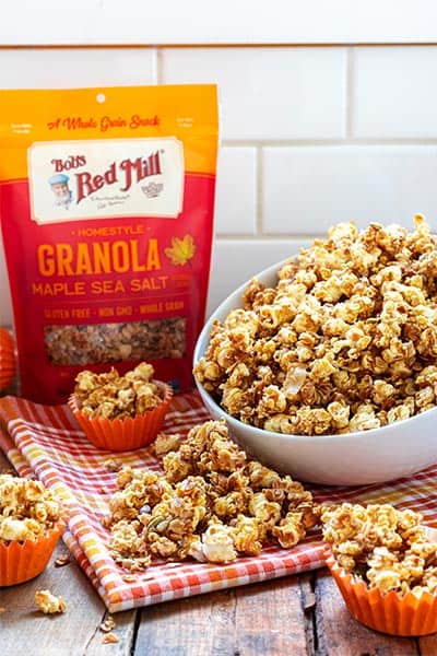 Bobs Red Mill granola packaging next to a bowl of popcorn
