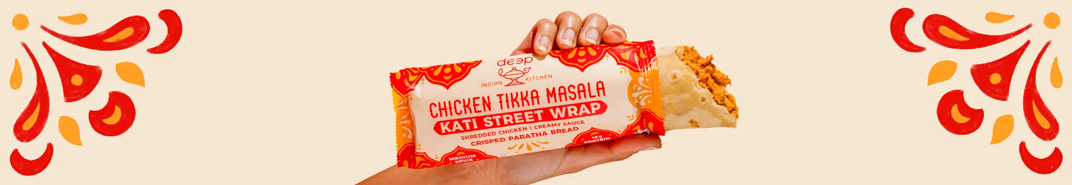 Hand holding chicken tikka masala street wrap