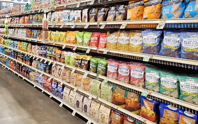 Grocery aisle with chips and cookies on shelves