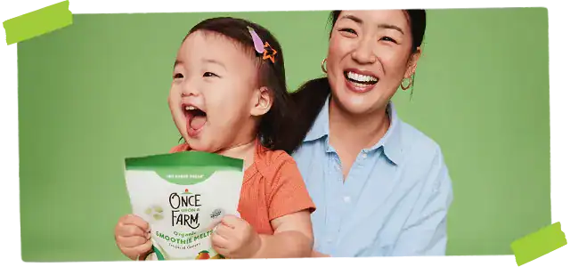 Child holding Once Upon a Farm smoothie melts