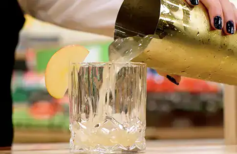 mocktail being poured from shaker