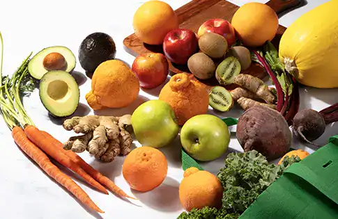 peak season produce falling out of a sprouts shopping bag