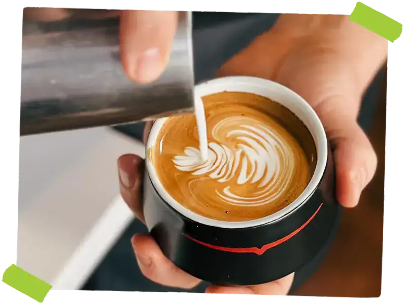 hand pouring a latte