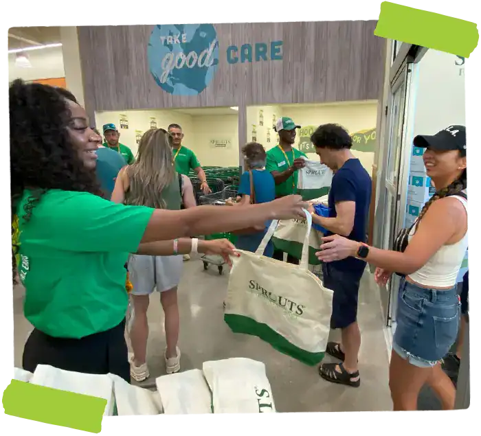 Sprouts employees handing out reusable bags